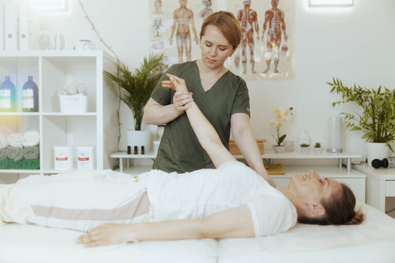 healthcare worker at a community health center examines her patient |Corporate Synergies