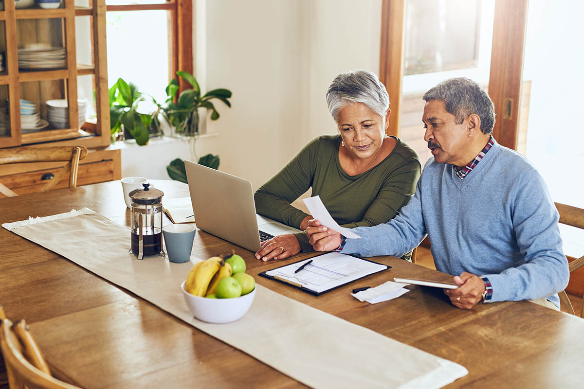 An older couple reviews the retirement support their jobs offer them. | Corporate Synergies