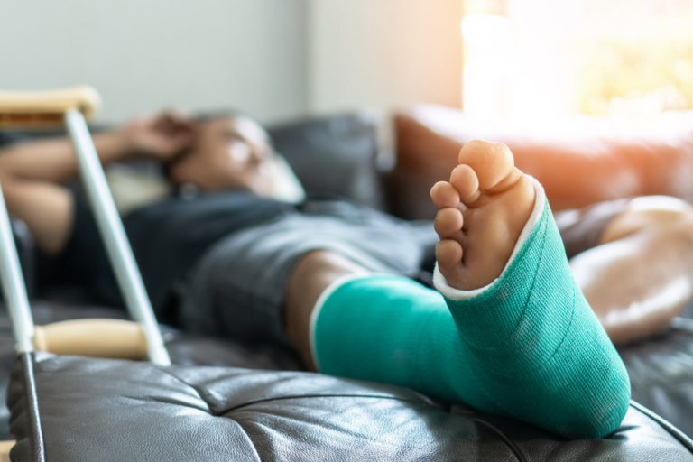 Man with broken foot on couch